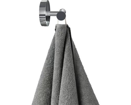 Sivý uterák visí na háku na uteráky