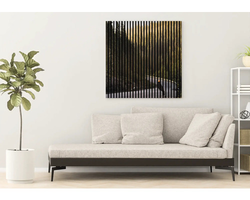 Obývacia izba s pohovkou a nástenným obrazom s motívom lesa