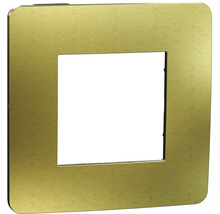 Štvorcový kryt vypínača zlatej farby.
