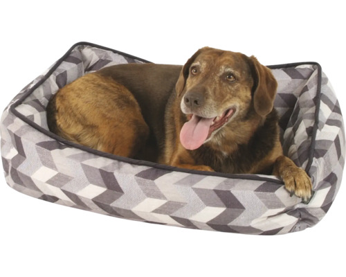 Pes leží v pelechu s geometrickým vzorom