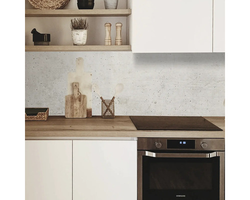 Kuchynská scéna s bielymi skrinkami, drevenou pracovnou doskou a betónovým pozadím