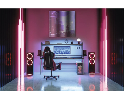 Herná miestnosť so stolom, stoličkou, reproduktormi a neónovým osvetlením