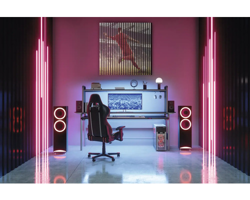 Zariadenie hernej izby so stolom, stoličkou, počítačom, reproduktormi a nástennou dekoráciou